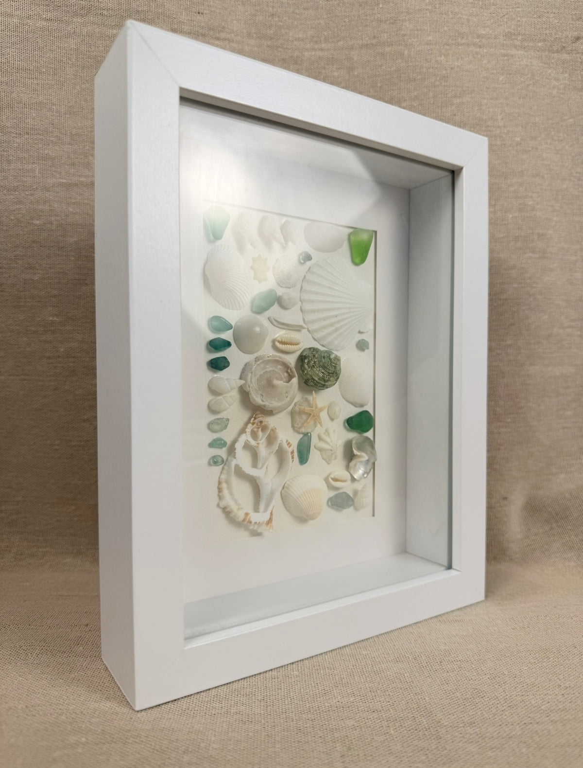 Blue Ocean Collection – Sea Glass & Shell Specimen Frame

Inspired by the vibrant colors of the ocean, this one-of-a-kind specimen frame features genuine seashells, coral, starfish, and striking blue sea glass.

Each element is thoughtfully arranged to hi