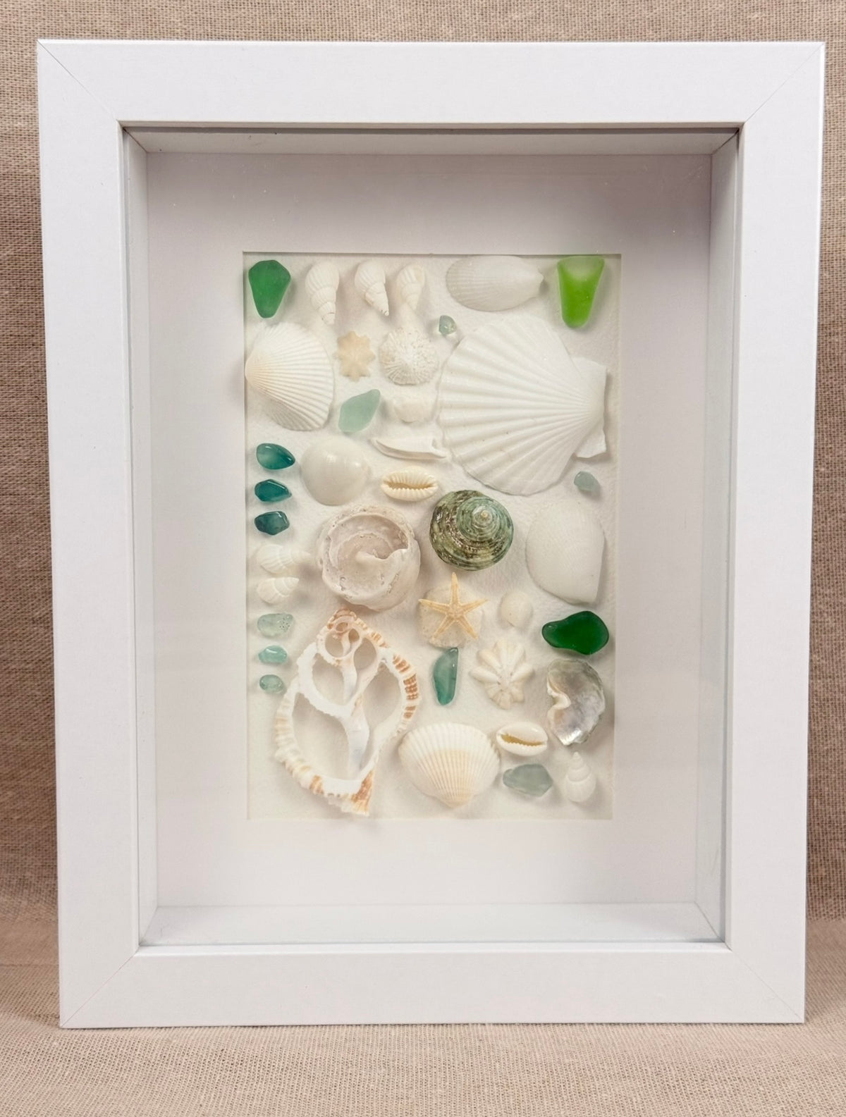 Blue Ocean Collection – Sea Glass & Shell Specimen Frame

Inspired by the vibrant colors of the ocean, this one-of-a-kind specimen frame features genuine seashells, coral, starfish, and striking blue sea glass.

Each element is thoughtfully arranged to hi