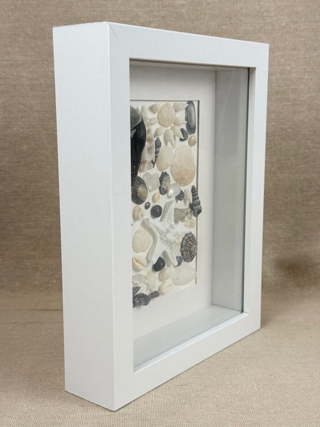 Shell Art – Coastal Collection

Bring a touch of the Australian coast into your home with this delicate handmade shell art.

A beautiful selection of natural seashells, sea glass and a small starfish are carefully arranged in soft shades of white, ivory a