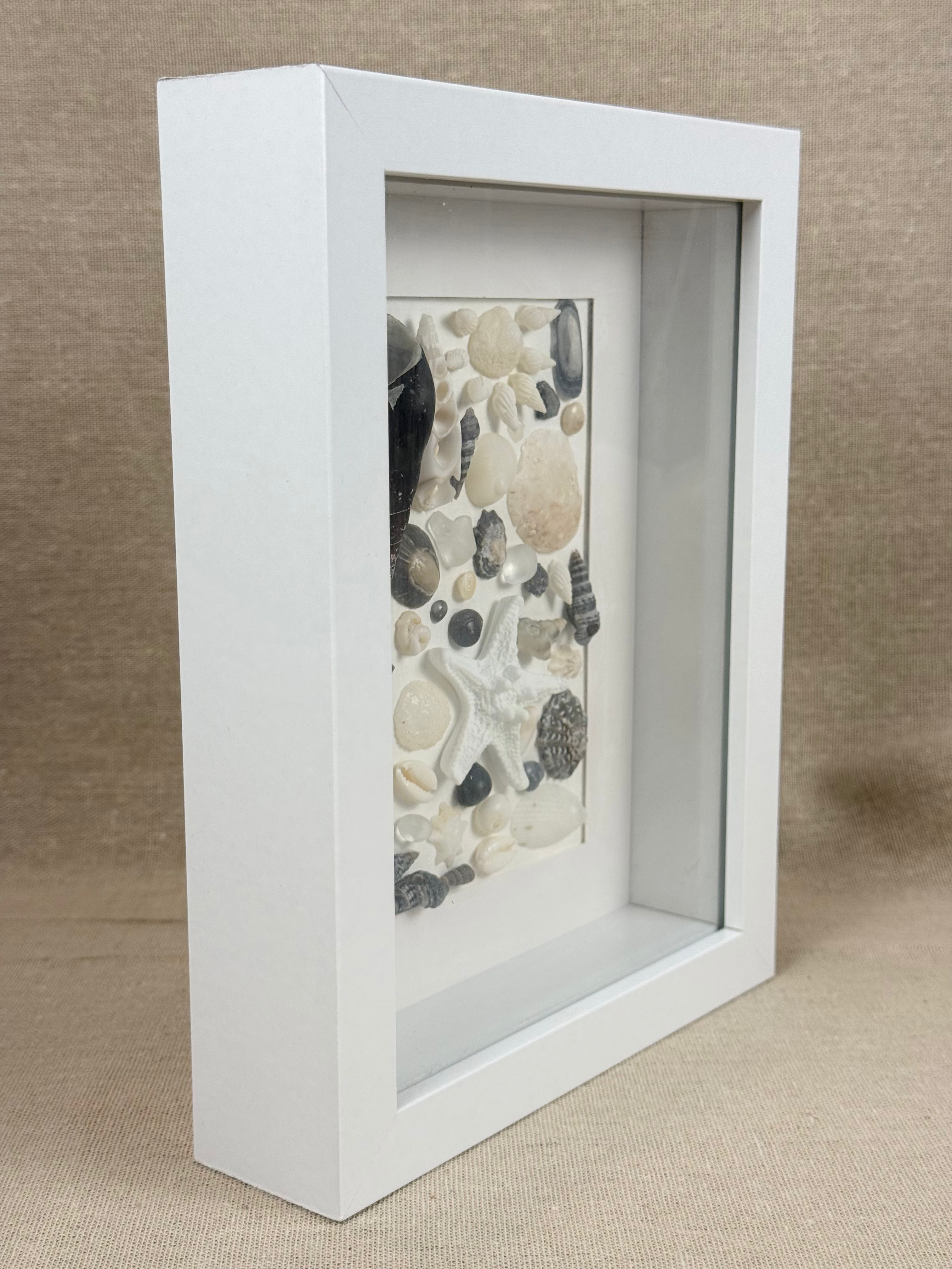 Shell Art – Coastal Collection

Bring a touch of the Australian coast into your home with this delicate handmade shell art.

A beautiful selection of natural seashells, sea glass and a small starfish are carefully arranged in soft shades of white, ivory a